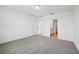 A bright bedroom with gray carpet and a door leading to the bathroom and walk-in closet at 4002 Copperleaf Ln, Poinciana, FL 34759