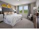 Serene bedroom with decorative headboard, and a view of lush greenery at 4002 Copperleaf Ln, Poinciana, FL 34759