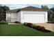 Charming single-story home with a manicured lawn and two car garage at 4002 Copperleaf Ln, Poinciana, FL 34759