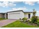 Inviting one-story home with a brick driveway, a two-car garage and a well-maintained lawn at 4002 Copperleaf Ln, Poinciana, FL 34759