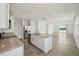 Open kitchen with granite countertops, stainless steel appliances, and a center island with a sink at 4002 Copperleaf Ln, Poinciana, FL 34759