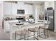 Modern kitchen features granite counters, white cabinets, and stainless steel appliances at 4002 Copperleaf Ln, Poinciana, FL 34759