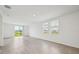 Large living room featuring tile flooring, lots of natural light, and sliding glass door to backyard at 4002 Copperleaf Ln, Poinciana, FL 34759
