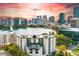 Striking aerial view of the condo building overlooking a picturesque lake and the vibrant downtown skyline at 401 E Robinson St # 101, Orlando, FL 32801