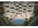 Aerial view of a condominium building with a pool, jacuzzi, and patio area at 401 E Robinson St # 101, Orlando, FL 32801