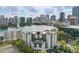 Stunning aerial view showcasing community features, city skyline, lake, and well-manicured landscaping at 401 E Robinson St # 101, Orlando, FL 32801
