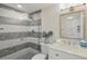 Stylish bathroom with white vanity, round mirror, and shower featuring unique mosaic tile work at 401 E Robinson St # 101, Orlando, FL 32801