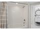 Bathroom featuring white tiled walls, shower/tub combo with gray-striped curtain and an elegant vanity at 401 E Robinson St # 101, Orlando, FL 32801