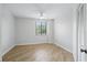 Clean bedroom with light wood flooring and a window with blinds that provide natural light at 401 E Robinson St # 101, Orlando, FL 32801