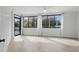 Light-filled bedroom features a balcony and a large window with views of the surrounding landscape at 401 E Robinson St # 101, Orlando, FL 32801
