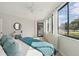 Bright bedroom featuring waterfront views, ensuite balcony access, and a cozy decor style at 401 E Robinson St # 101, Orlando, FL 32801