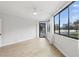 Bright bedroom with light wood floors, neutral walls, and a large window providing beautiful outdoor views at 401 E Robinson St # 101, Orlando, FL 32801