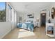 Light-filled primary bedroom with neutral tones, a large window, and stylish furnishings at 401 E Robinson St # 101, Orlando, FL 32801