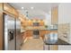 Bright kitchen featuring stainless steel appliances, stylish wood cabinets, and a convenient eat-in bar area at 401 E Robinson St # 101, Orlando, FL 32801