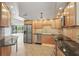 Modern kitchen featuring stainless steel appliances, granite countertops, maple cabinets and open to living spaces at 401 E Robinson St # 101, Orlando, FL 32801