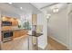 Well-lit kitchen with stainless steel appliances, wood cabinets, and mosaic backsplash, plus an adjacent hallway at 401 E Robinson St # 101, Orlando, FL 32801