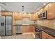 Well-equipped kitchen with stainless steel appliances, granite countertops, and maple cabinets at 401 E Robinson St # 101, Orlando, FL 32801