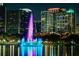 Night view of Lake Eola fountain with city buildings reflected in the water at 401 E Robinson St # 101, Orlando, FL 32801