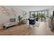 Stylish living room featuring hardwood floors, a comfortable sofa, bench, and a view of the outdoor balcony at 401 E Robinson St # 101, Orlando, FL 32801