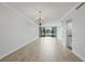 Large living area with tiled floors, balcony access, and built-in bar area with a chandelier at 401 E Robinson St # 101, Orlando, FL 32801