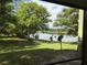 Backyard view with lush green grass and lake at 4120 Plantation Cove Dr # 301, Orlando, FL 32810