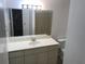 Well-lit bathroom featuring a large mirror, vanity with white countertops and sink, and a toilet at 4120 Plantation Cove Dr # 301, Orlando, FL 32810