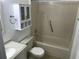 Bright bathroom with a bathtub and shower, updated vanity, toilet, and storage at 4120 Plantation Cove Dr # 301, Orlando, FL 32810