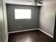 Bedroom with dark laminate flooring, a ceiling fan, and a window for natural light at 4120 Plantation Cove Dr # 301, Orlando, FL 32810