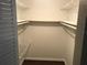 Bright walk-in closet with installed wire shelving and a hardwood floor at 4120 Plantation Cove Dr # 301, Orlando, FL 32810