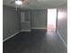 A spacious living room with modern gray walls and hardwood floors transitions to a dining area at 4120 Plantation Cove Dr # 301, Orlando, FL 32810
