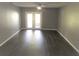 A spacious living room with modern gray walls and a ceiling fan leads to a private balcony at 4120 Plantation Cove Dr # 301, Orlando, FL 32810