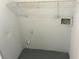 Utility room has white walls, a shelf, and utility connections at 4120 Plantation Cove Dr # 301, Orlando, FL 32810