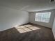 Bright bedroom with neutral carpet and white walls featuring a window with natural light at 4154 Versailles Dr # 4154D, Orlando, FL 32808