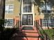 Building with brown double doors and brick steps leading up to entrance and iron railings at 4154 Versailles Dr # 4154D, Orlando, FL 32808