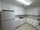 Bright kitchen with white cabinets, marble countertops, and modern appliances at 4154 Versailles Dr # 4154D, Orlando, FL 32808