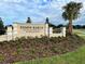 Community entrance sign for Tyson Ranch Townhomes, set amidst lush landscaping and a clear blue sky at 4315 Campsite Loop, Orlando, FL 32824
