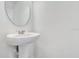 Bathroom featuring a pedestal sink, elegant mirror, and minimalist design at 509 Madison Dr, Davenport, FL 33837