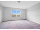 Carpeted bedroom with a large window, offering natural light and a view of the outdoors at 509 Madison Dr, Davenport, FL 33837