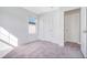 Bright bedroom featuring carpet, a window, and a white door at 509 Madison Dr, Davenport, FL 33837
