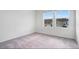 Empty bedroom with neutral carpet, large windows offering a view of neighboring homes, and ample natural light at 509 Madison Dr, Davenport, FL 33837