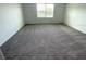 Bright bedroom with plush carpeting and a large window at 509 Madison Dr, Davenport, FL 33837