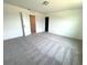 Bedroom with neutral walls, carpet, and doorways at 509 Madison Dr, Davenport, FL 33837
