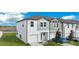 Attractive two-story home with a one-car garage, green lawn, and blue car parked in front at 509 Madison Dr, Davenport, FL 33837