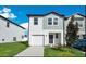Charming two-story home featuring a one-car garage, manicured lawn, and well-maintained landscaping at 509 Madison Dr, Davenport, FL 33837