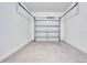 Clean, spacious garage with a concrete floor and white garage door at 509 Madison Dr, Davenport, FL 33837