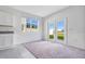 Cozy living room features plush carpet, a large window and doors to the backyard at 509 Madison Dr, Davenport, FL 33837