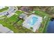Aerial view of community pool, lounge chairs, and manicured green space at 509 Madison Dr, Davenport, FL 33837