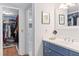 Bathroom showcasing blue vanity, decorative mirrors, and access to closet at 530 E Central Blvd # 303, Orlando, FL 32801