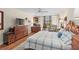 Comfortable bedroom featuring a desk, ample dresser space, and balcony access at 530 E Central Blvd # 303, Orlando, FL 32801