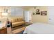 Well-lit bedroom with a seating area, closet, and neutral decor at 530 E Central Blvd # 303, Orlando, FL 32801